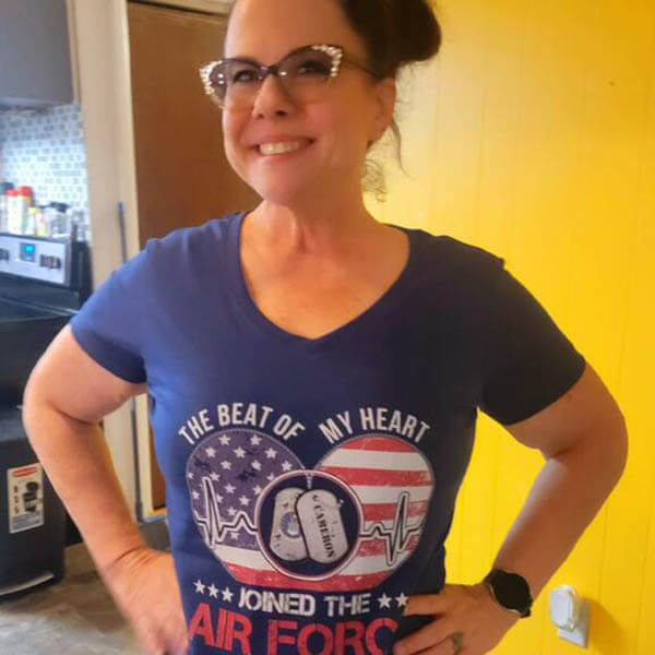 air force mom proudly show off her new graphic tee in her office