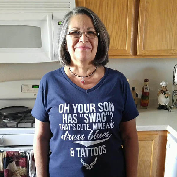 air force mom smiling and standing in the kitchen to show her dress blues tattoos graphic design t shirt