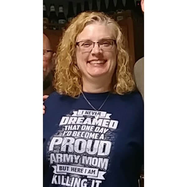 a woman wearing a blue t-shirt with text about being a proud army mom.