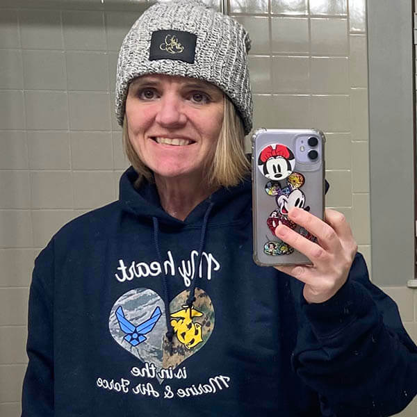 mom of airman and marine taking a selfie photo in front of a mirror