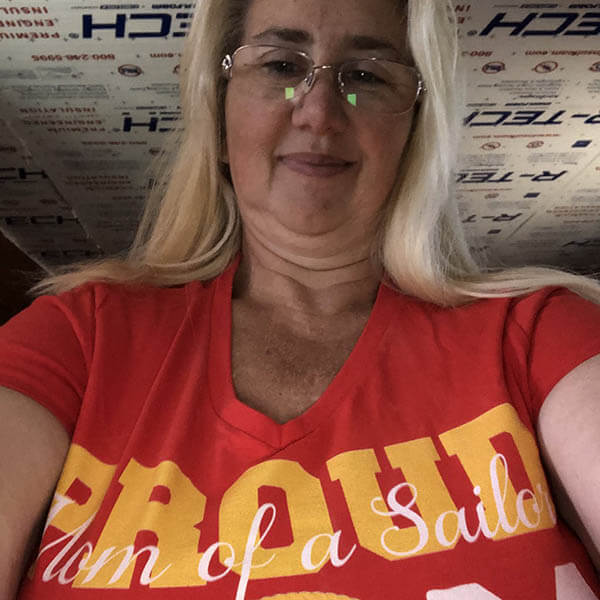 navy mom proudly show off her shirt while taking a selfie photo