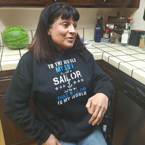 navy mom talking in the kitchen wearing her favorite hoodie